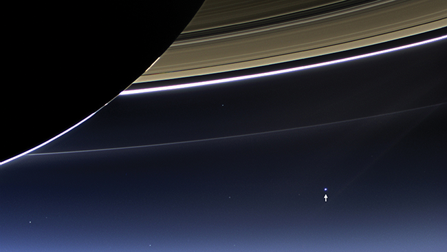 Dubbed “The Day the Earth Smiled,” this image was taken on July 19, 2013, by NASA’s Cassini spacecraft and shows Saturn’s rings, but also (as indicated by the arrow) planet Earth.